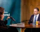 Daron Acemoglu being interviewed at a table for Bloomberg Weekend