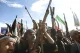 Houthi fighters raise rifles during a rally in Yemen