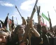 Houthi fighters raise rifles during a rally in Yemen