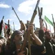 Houthi fighters raise rifles during a rally in Yemen