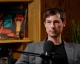 Reed Jobs seated in front of a microphone during an interview