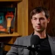 Reed Jobs seated in front of a microphone during an interview