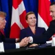 Trump shaking hands with Danish officials at a signing event
